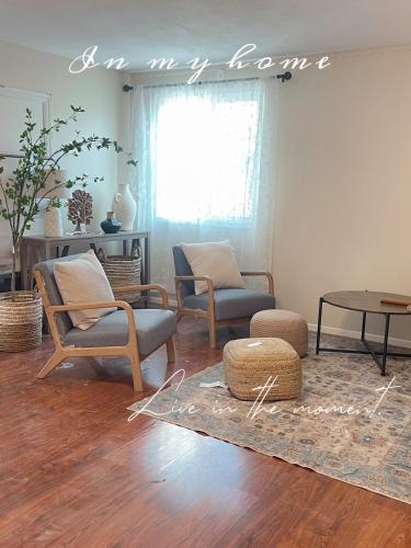 a living room with chairs and a table at Tao house in La Verne