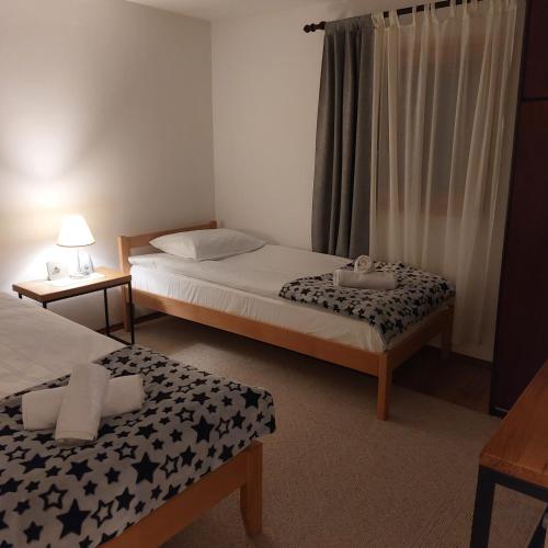 a bedroom with two beds and a window at Udahni prirodu in Raška