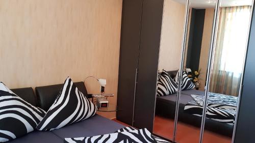 een kamer met zwart-witte kussens op een bank bij ALACARD Ferienwohnungen Höffgen Thale Harz in Thale