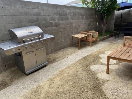 a barbecue grill and a table and a bench at Ocean View / Pool Table / Surfboards / Beach Bikes in Oxnard