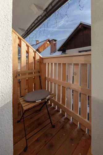 a balcony with a table on a wooden deck at Deluxe Apartments 55 in Kranjska Gora
