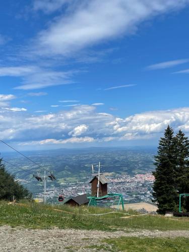 a house on a hill with a view of a city at Pohorje 11 in Hočko Pohorje