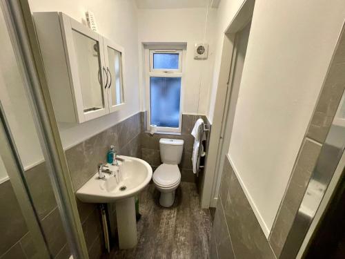 a small bathroom with a toilet and a sink at Self Contained 1 Bedroom Duplex in Leicester