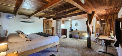 a bedroom with a large bed and a desk at LiberaLiCostaRica in Marbella