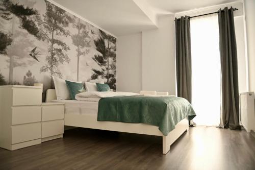 a white bedroom with a bed and a window at Mathias Airport Residences & Therme-Self Check-in in Otopeni