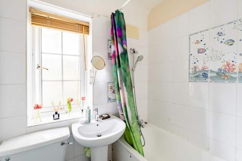 a bathroom with a sink and a toilet and a shower at Morden House in Morden