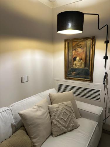 a living room with a white couch and a lamp at Dimora San Giovanni in Nardò