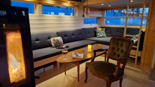 a living room with a couch and a table at Sveheim - cabin with an amazing view in Flå