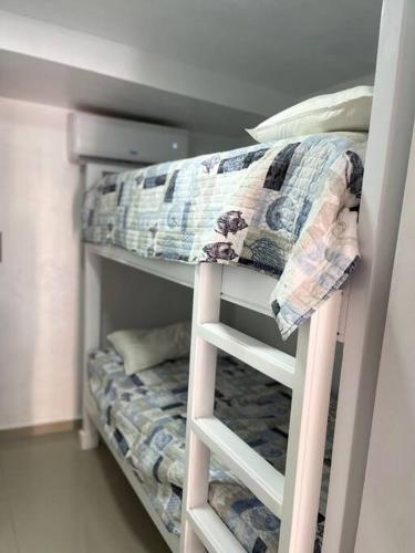 a bunk bed with pillows on top of it at Apartamento de Lujo En San Pedro in San Pedro de Macorís