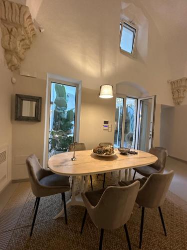 a dining room with a wooden table and chairs at Dimora San Giovanni in Nardò
