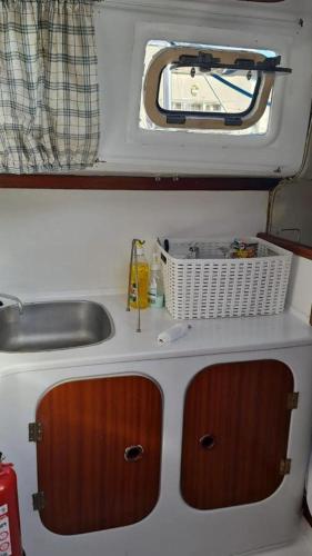 a kitchen with a sink and a sink at Veleiro em Belém in Lisbon