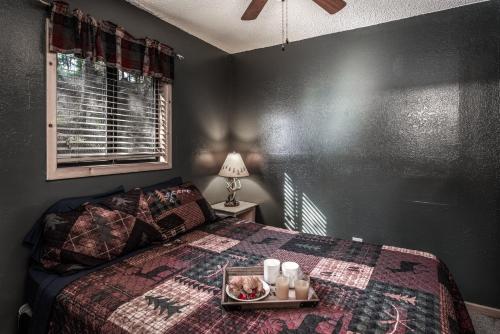 a bedroom with a bed with a tray of food on it at Upper Canyon Inn & Cabins in Ruidoso