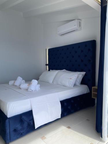 a blue bed with two stuffed animals on it at Qeparo Napolon Complex in Qeparo