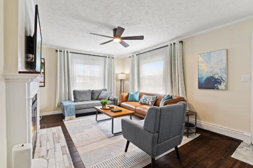 a living room with a couch and a ceiling fan at Charming Home in Speedway in Indianapolis