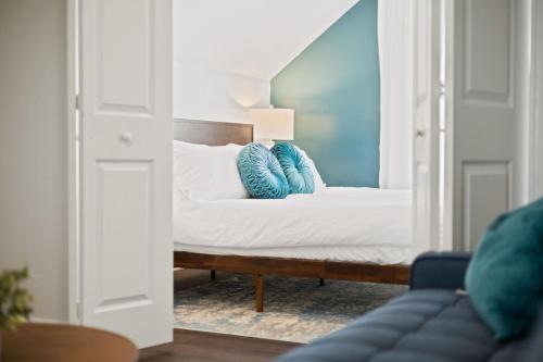a bedroom with a bed with blue pillows on it at Charming Home in Speedway in Indianapolis
