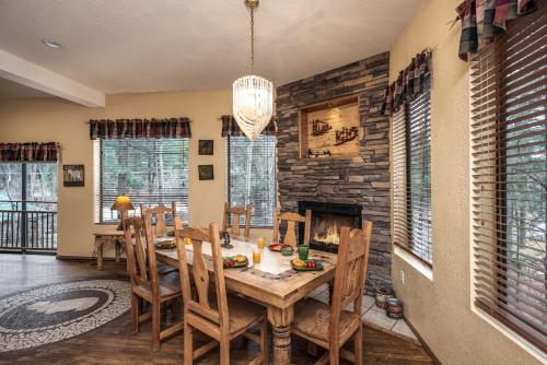 a dining room with a table and a fireplace at Upper Canyon Inn & Cabins in Ruidoso