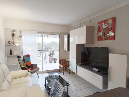 un salon avec un canapé et une télévision dans l'établissement Baie d'Azur, à Saint-Raphaël