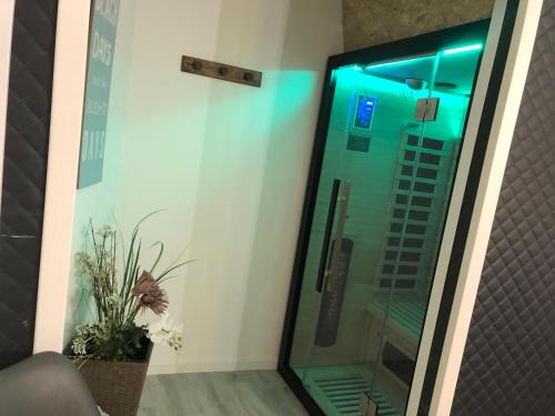 a shower with blue lights in a room at Eresburg Apartment. in Marsberg