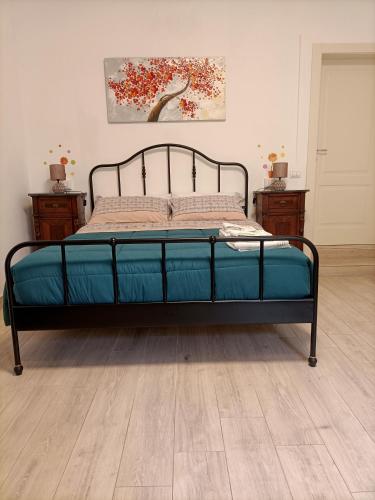 a bed with a metal frame in a bedroom at Affittacamere Il Chiostrino Guest House in Florence