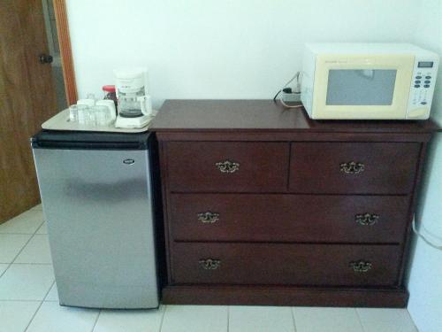 a microwave sitting on top of a dresser with a microwave oven at Nature Resort in Bermudian Landing