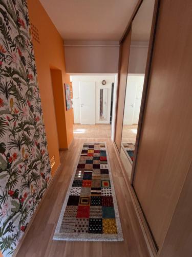 a hallway with a chessboard floor in a house at Király Családi Apartman- Royal Family Apartment in Budapest