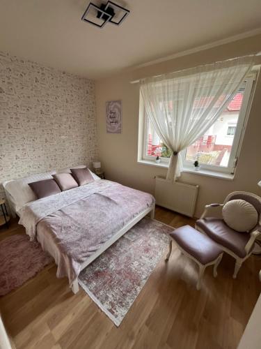 a bedroom with a large bed and a window at Király Családi Apartman- Royal Family Apartment in Budapest