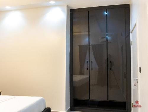 a bathroom with a shower and a bed at 99 MOZILLA APARTMENTS AND SUITES in Abuja