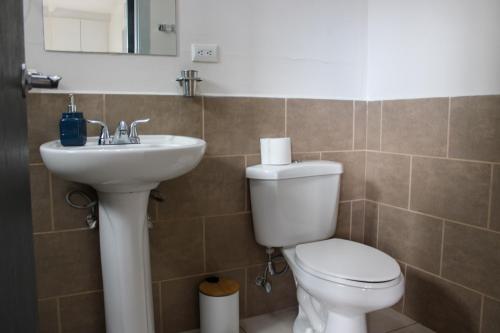 a bathroom with a toilet and a sink at Great family apartment in Tegucigalpa in Tegucigalpa