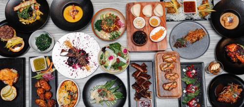 a table with many plates of food on it at Kimpton Hotel Palomar Los Angeles Beverly Hills by IHG in Los Angeles