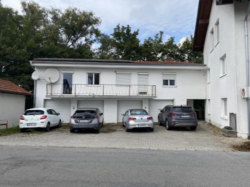 a group of cars parked in front of a building at 3 Zimmer Apartment mit Flussblick - Self Check-In in Eggenfelden