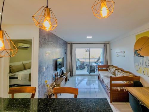 a living room with a couch and a table at Aloha Vibes Ap Cumbuco - Green Club in Cumbuco