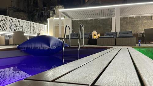 a pool with a table in a room with chairs at Domus Aquae Rooms & Wellness in Genova