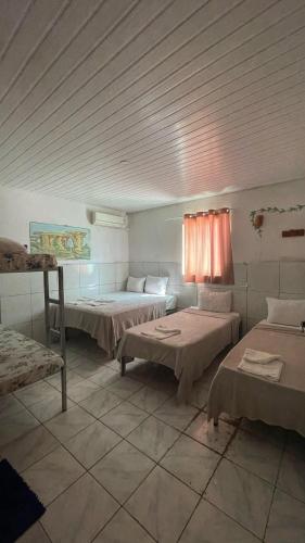 a room with two beds in a room with at Pousada vista pro vale do catimbau in Catimbau