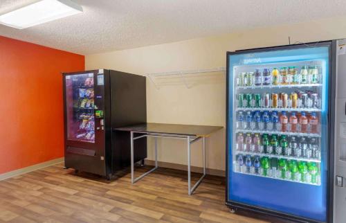 a soda machine and a table in a drink cooler at Extended Stay America Select Suites - Raleigh - RDU Airport in Morrisville