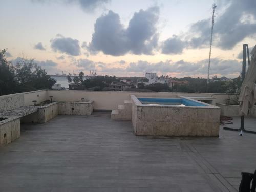 a swimming pool on the roof of a building at Penthouse across from the beach in La Piedra
