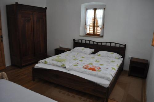 a bedroom with a bed with a white comforter at Apartments Koptur in Škocjan