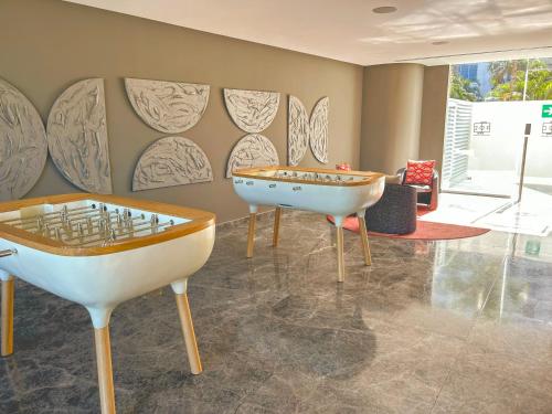 a room with two tables and a ping pong table at Gorgeous Bucerias Penthouse TAYAU in Bucerías