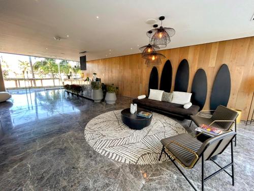 a living room with a couch and a table at Gorgeous Bucerias Penthouse TAYAU in Bucerías