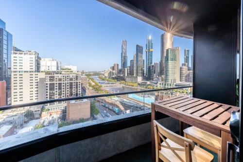 a balcony with a view of a city skyline at Aura2107, CBD Entire 2 Bedroom Apartment with Balcony and Stunning Yarra River Views in Melbourne