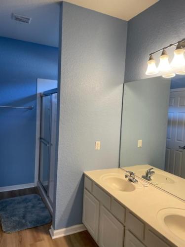 a bathroom with a sink and a mirror at Windsor Hills Resort 5BR Villa, Amenities, Private Pool & Water Park, Near Disney, Sea World, Universal in Orlando