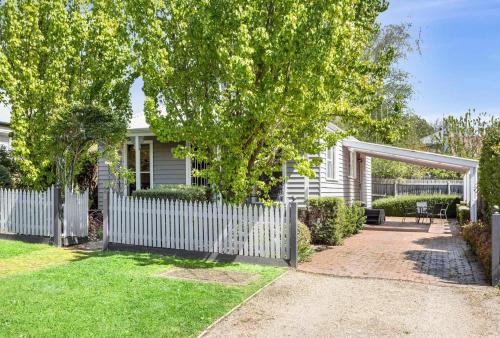 a white fence in front of a house at Birdie Daylesford in Daylesford