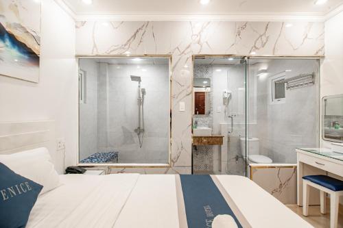 a bathroom with a large bed and a shower at Venice Hotel in Ho Chi Minh City