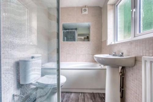 a bathroom with a tub and a sink and a shower at Comfy Contractor Stay in Stoke - Free Parking in Stoke on Trent