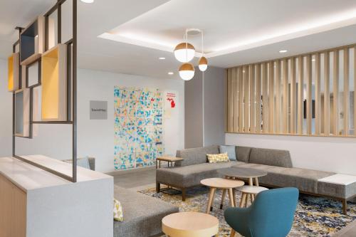 a waiting room with a couch and tables at TownePlace Suites by Marriott Iron Mountain in Iron Mountain