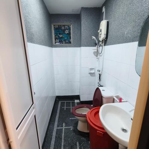 a small bathroom with a toilet and a sink at Farhah Homestay Selayang Kuala Lumpur - malay only in Batu Caves