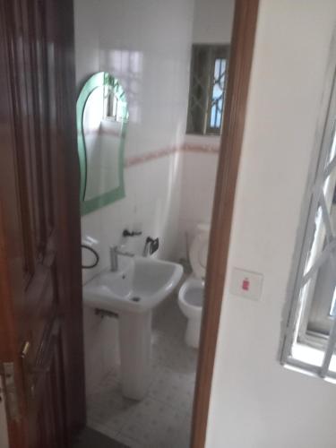 a bathroom with a sink and a toilet at Anc mall area east legon guest house in Accra