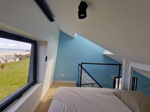 une chambre avec un lit et une grande fenêtre dans l'établissement Flat in France near Sandy Beaches, à Locquirec