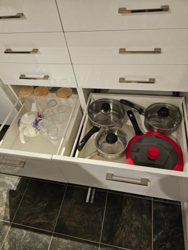 a kitchen with a stove with pots and pans at Wanaka Deluxe Studio in Wanaka