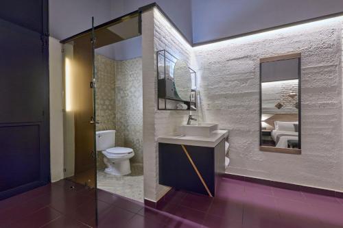 a bathroom with a toilet and a sink and a mirror at City Centro by Marriott Ciudad de Mexico in Mexico City