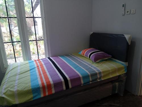 Ένα ή περισσότερα κρεβάτια σε δωμάτιο στο Siroen Homestay
